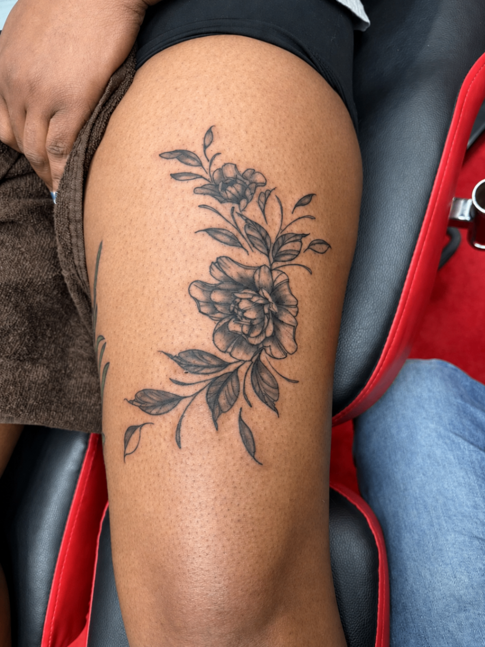Tatouage Fine Line d’un bouquet de fleurs sur la cuisse